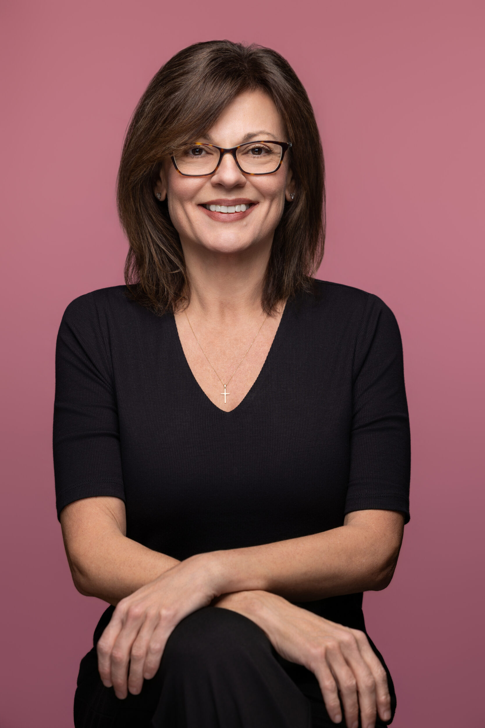 Dr. T pink backround sitting